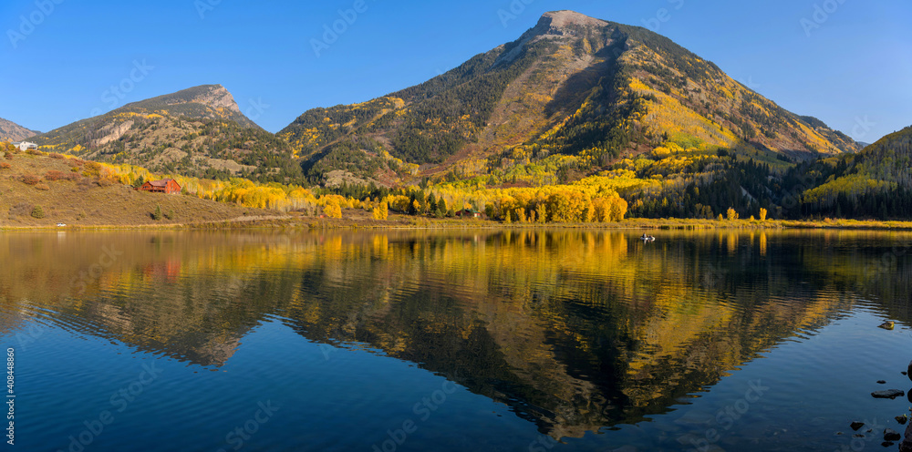 Autumn at Beaver Lake - A panoramic view of Whitehouse Mountain reflecting in calm Beaver Lake on a sunny Autumn evening, Marble, Colorado, USA.