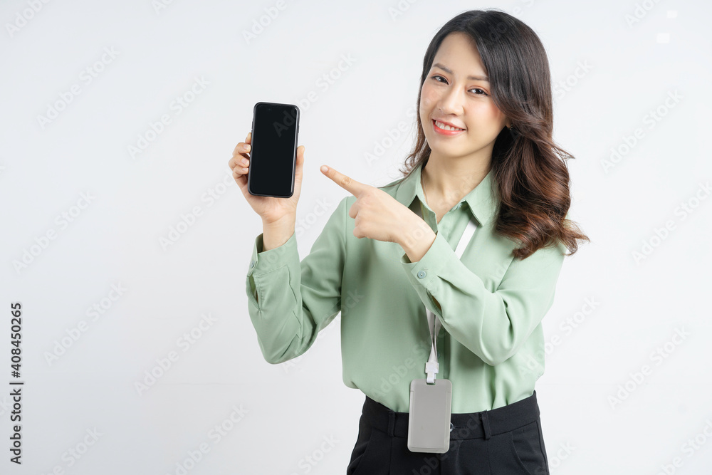 Portrait of a beautiful Asian businesswoman pointing her finger at a blank phone screen Portrait of a beautiful Asian businesswoman pointing her finger at a blank phone screen