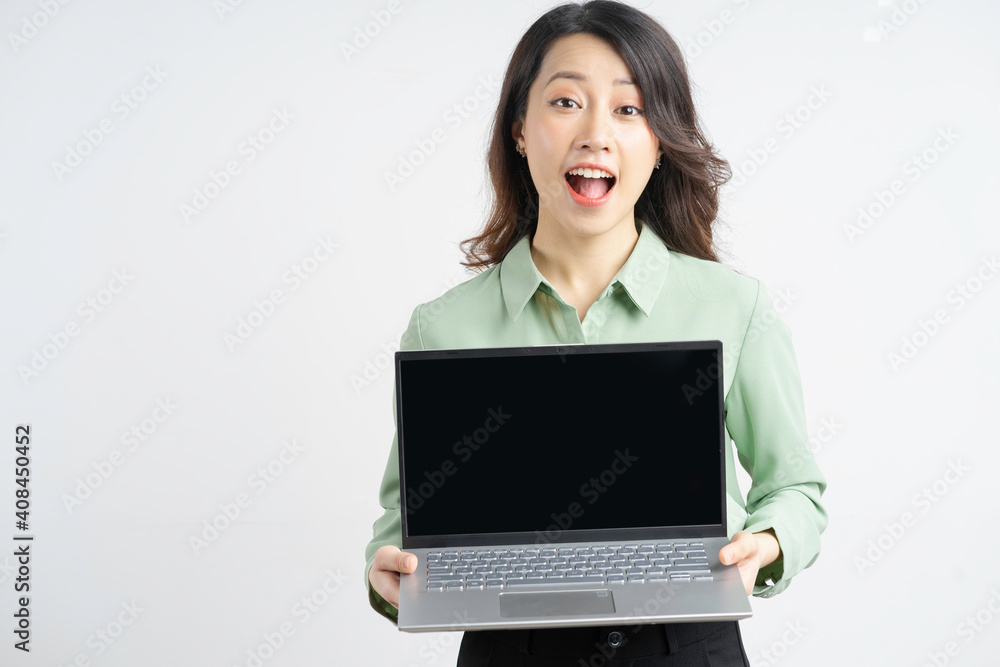 Portrait of a beautiful Asian businesswoman holding her laptop with an empty screen Portrait of a beautiful Asian businesswoman holding her laptop with an empty screen