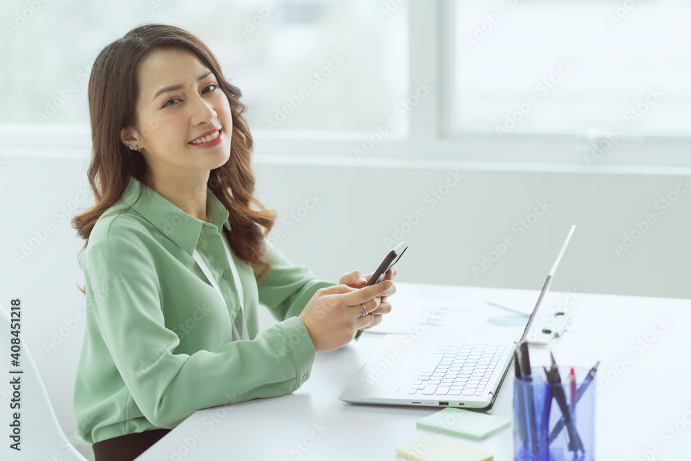 Beautiful Asian businesswoman sitting working at office Beautiful Asian businesswoman sitting working at office