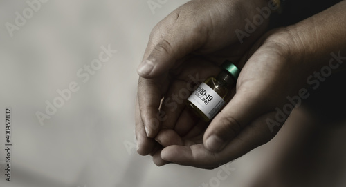 Картината върху платно Dirty hands of poor boy holding  Coronavirus COVID-19 vaccine vial