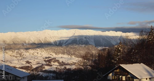 Snow-Covered Mountains With Blue Sky At Sunrise - Wide Shot photo