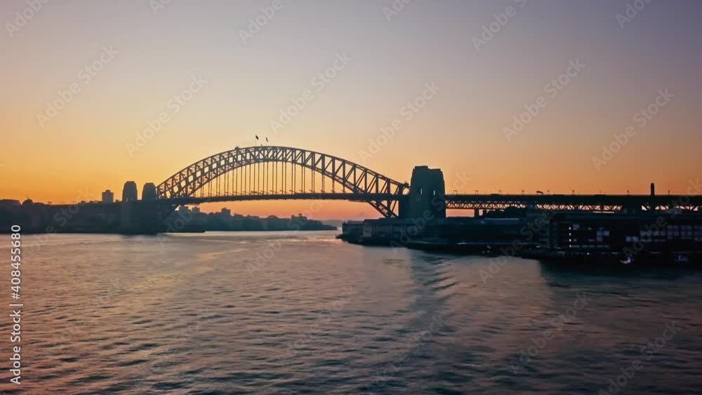Aerial panorama of the Sydney Harbour Bridge, over the calm water at sunrise. Aerial panorama of the Sydney Harbour Bridge, over the calm water at sunrise.