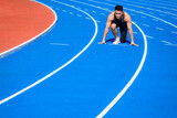 Male  athlete on  race track is ready to run