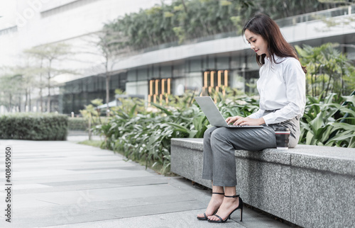 businesswoman working on laptop outdoors