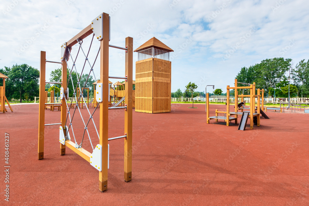 The rope net equipment on a child playground with the natural surface covered by red clay The rope net equipment on a child playground with the natural surface covered by red clay