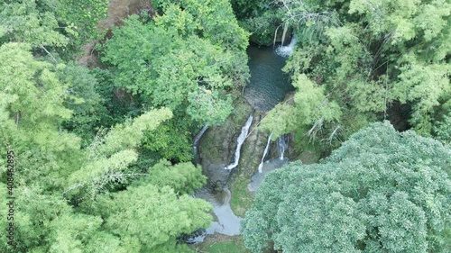 Descending aerial of a cascading waterfall in the jngle of the Caribbean island of Tobago photo