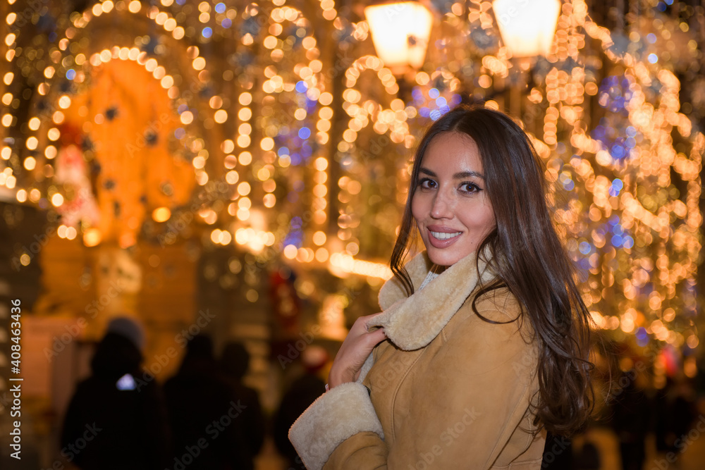 Happy beautiful girl under new year festive lights Happy beautiful girl under new year festive lights