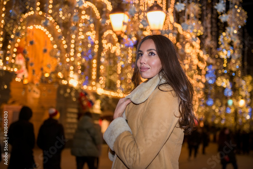 Happy beautiful girl under new year festive lights