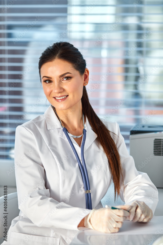 pediatrician making notes, she is is a working place of physician. healthcare, insurance and medicine concept pediatrician making notes, she is is a working place of physician. healthcare, insurance and medicine concept