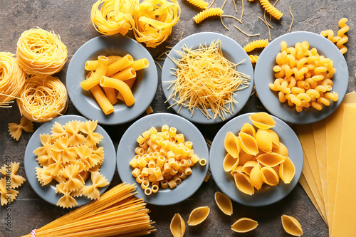 Assortment of dry pasta on grunge background