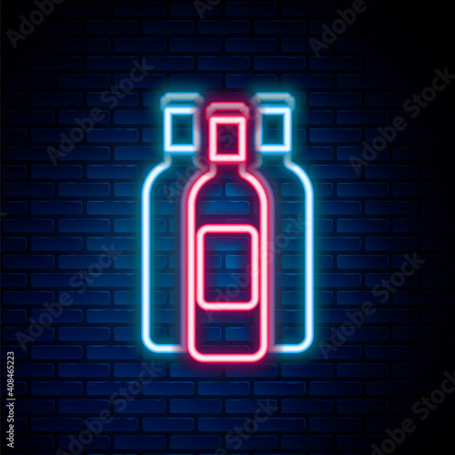 Glowing neon line Bottles of wine icon isolated on brick wall background. Colorful outline concept. Vector.