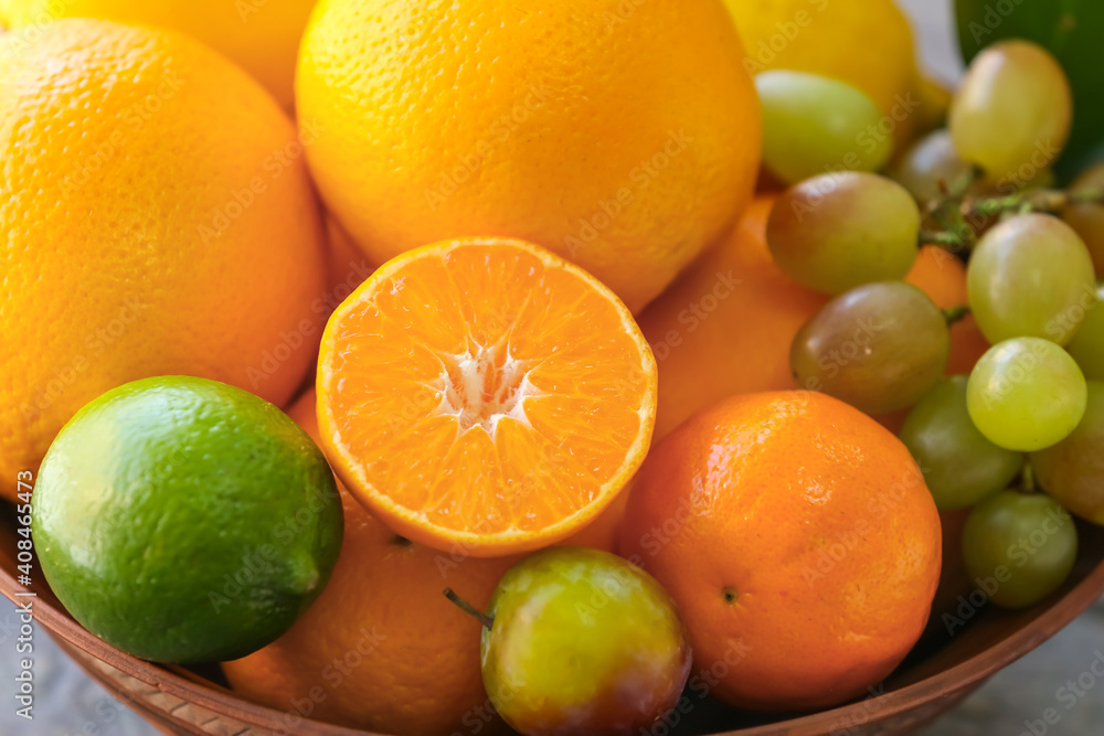 Bowl with different fruits on table, closeup Bowl with different fruits on table, closeup
