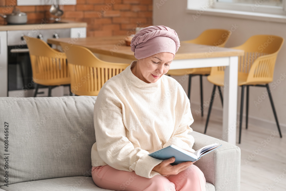 Mature woman after chemotherapy reading book at home Mature woman after chemotherapy reading book at home