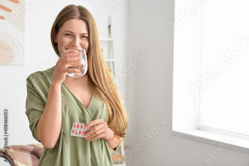 Beautiful young woman takin...