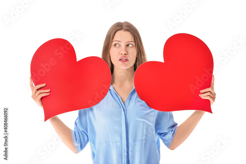 Troubled woman with red hearts on white background