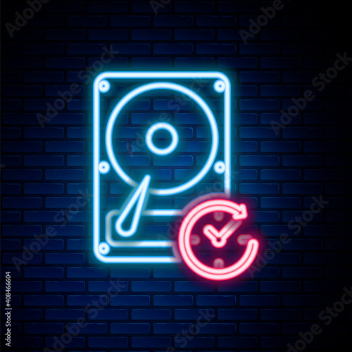 Glowing neon line Hard disk drive with clockwise sign, data recovery icon isolated on brick wall background. Colorful outline concept. Vector.