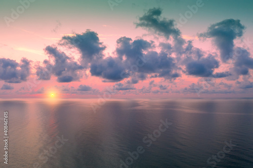 Early morning on the beach. Pink-purple dawn over the sea. Pastel color