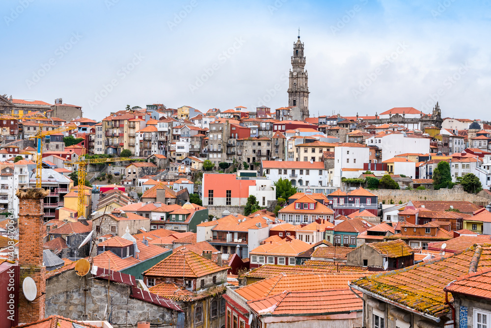 Roofs of houses and the Clerigos Tower of Porto, Portugal, example of the Baroque style built in the 18th century