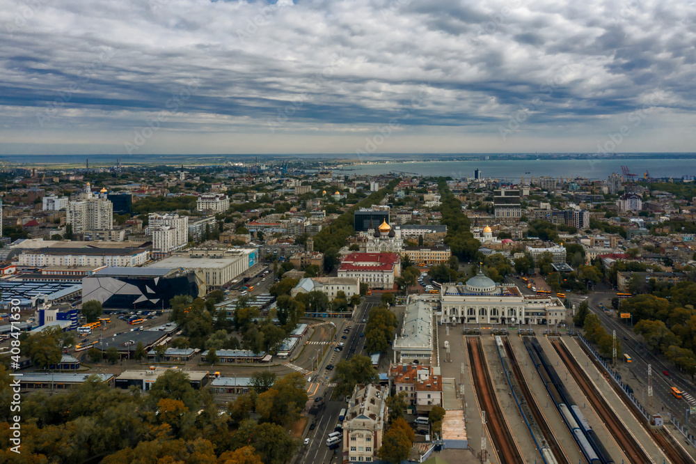 Fototapeta premium Main train station of Odessa Ukraine and city landscape. Drone footage, cloudy sky..