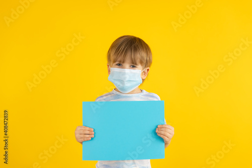 Portrait of kid wearing protective mask against yellow background