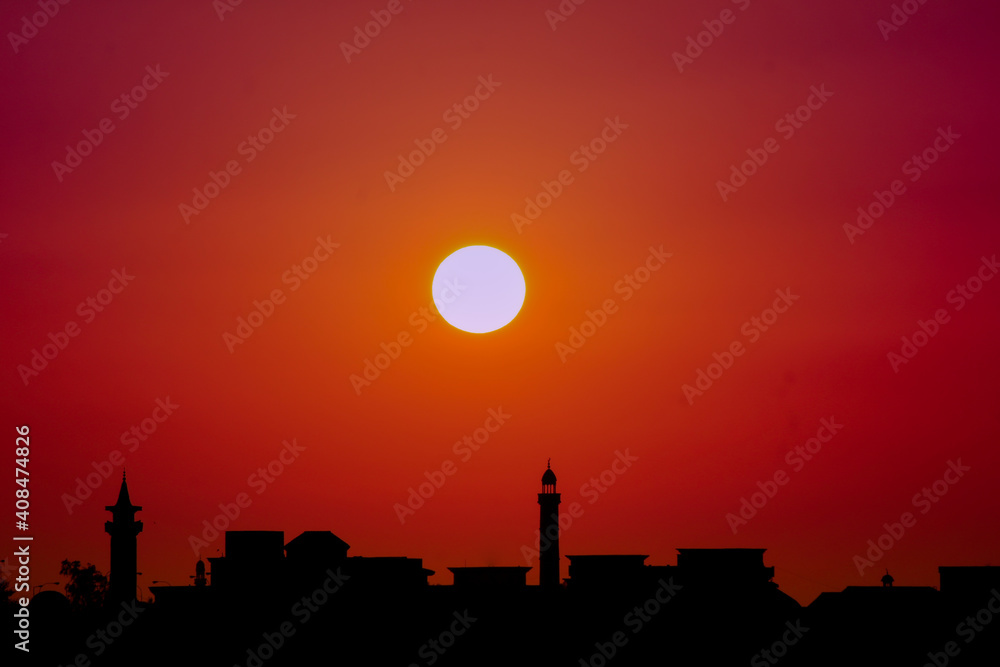 Fototapeta premium Sunset background in river with the mosque in th shadow.