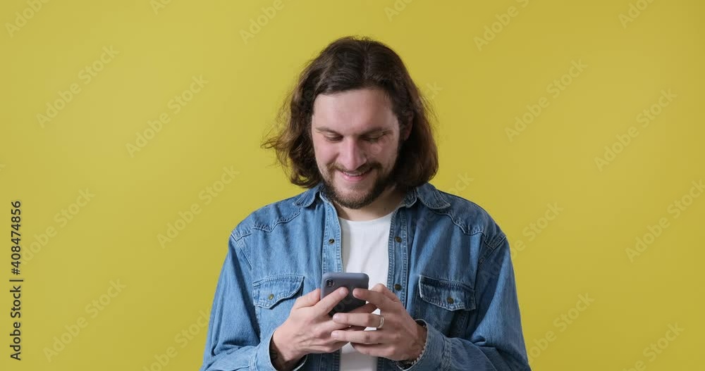Man messaging on mobile phone and showing device screen with green chroma key background Man messaging on mobile phone and showing device screen with green chroma key background