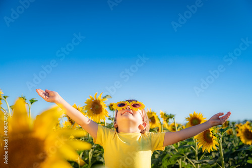 Happy child playing outdoor in spring field photo