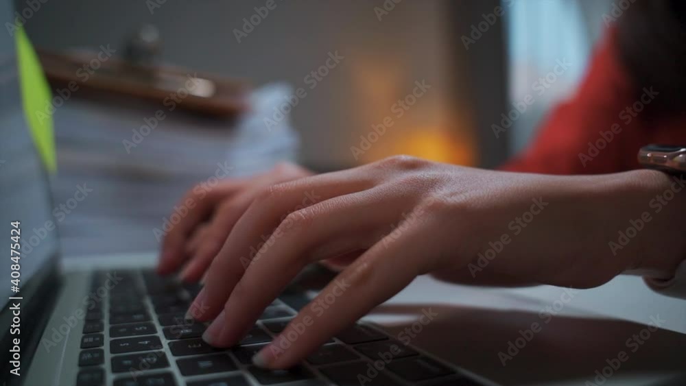 Female fingers-hands tapping, texting, and typing on the keyboard, finishing online tasks with laptop computer in the living room home office indoors. Female fingers-hands tapping, texting, and typing on the keyboard, finishing online tasks with laptop computer in the living room home office indoors.