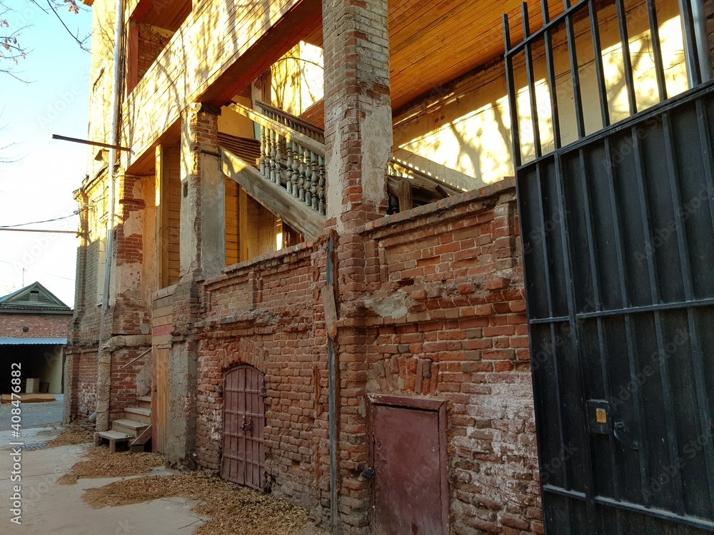 Old dilapidated brick house with old doors Old dilapidated brick house with old doors
