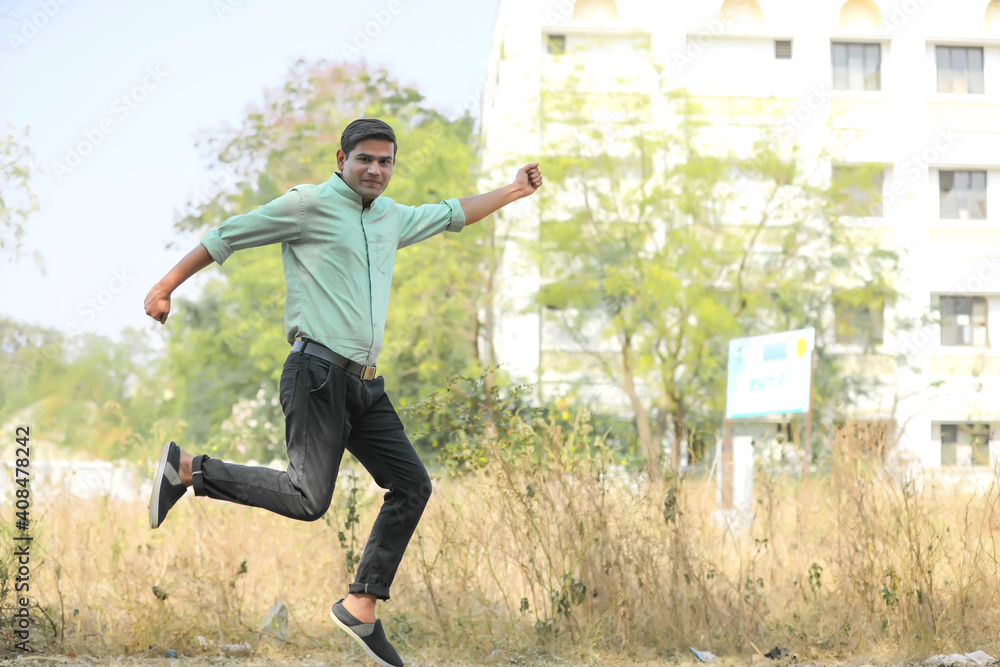 Young indian man Jump in air after achieving success. Young indian man Jump in air after achieving success.