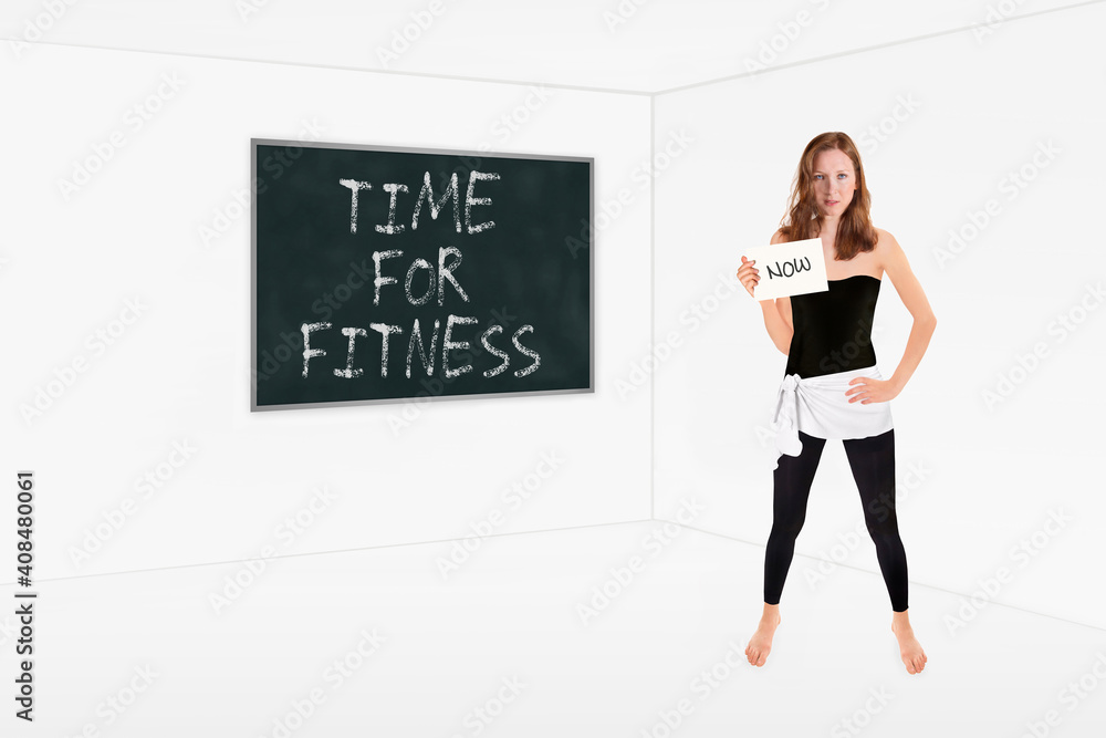 Athletic slim women in front of a chalkboard holding a placard, time for fitness is written on the board, now is written on the paper in her hand Athletic slim women in front of a chalkboard holding a placard, time for fitness is written on the board, now is written on the paper in her hand