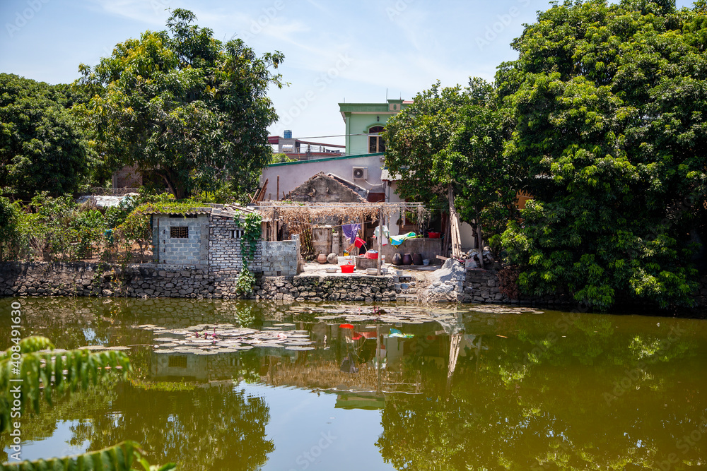 Obraz premium A house by the water of Vietnamese peasants,-Cat Ba Island, Vietnam