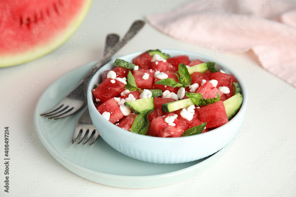 Delicious salad with watermelon, cucumber and cheese on white table, closeup