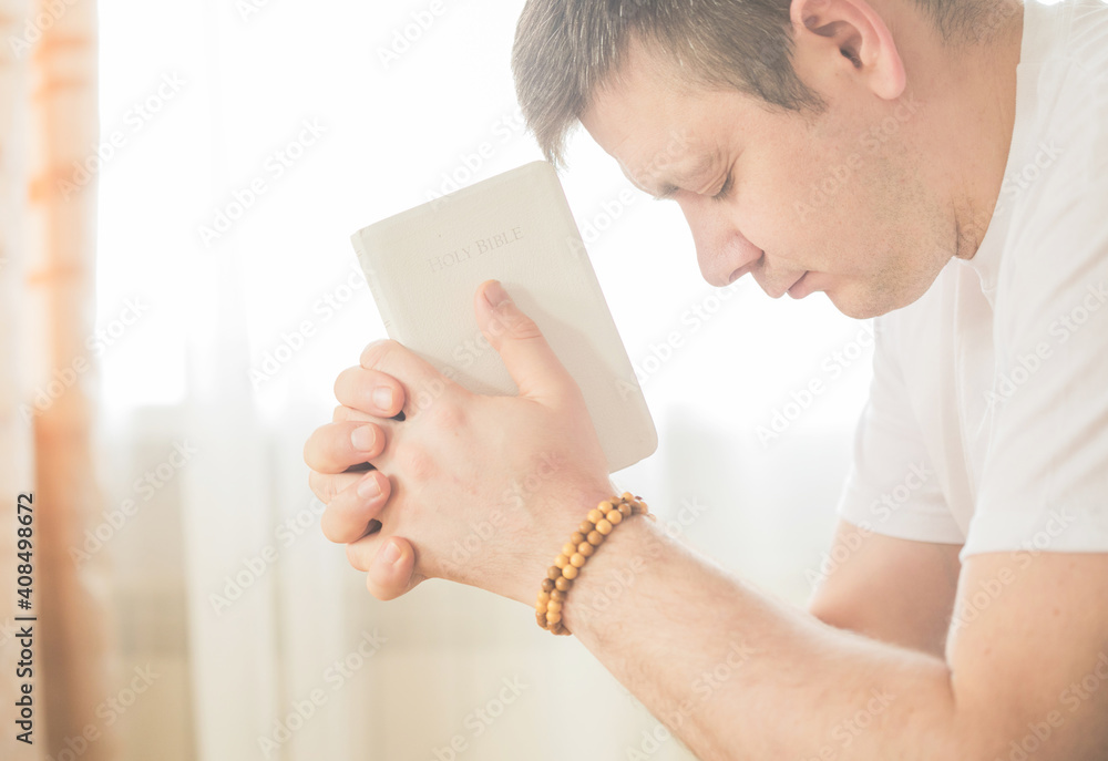 The Christian holds the Bible in his hands. The concept of faith, spirituality and religion. Prayer for prayer The Christian holds the Bible in his hands. The concept of faith, spirituality and religion. Prayer for prayer