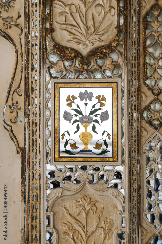 Floral pattern in mirror decorating a wall in Amber Fort, India