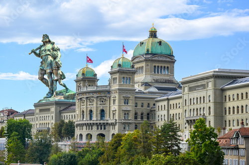 photo montage of the bundeshaus in Bern with the statue of William Tell and his son on the roof