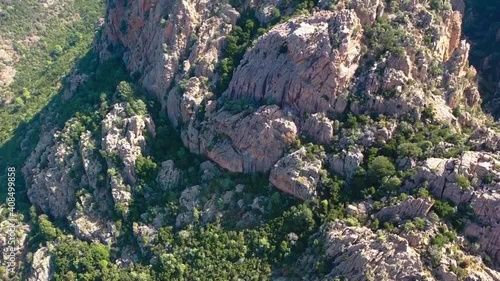Aerial video from Calanques de Piana. Corsica red rocks located in Piana, between Ajaccio and Calvi. Over the  Mountains range  we see the Golf of Porto. Tourism and vacations concept. photo