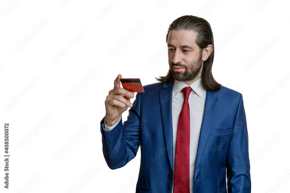 Charismatic businessman with a beard and long hair in a blue jacket and red tie with credit cards in his hand isolated on a white background. Portrait of an office worker. Charismatic businessman with a beard and long hair in a blue jacket and red tie with credit cards in his hand isolated on a white background. Portrait of an office worker.