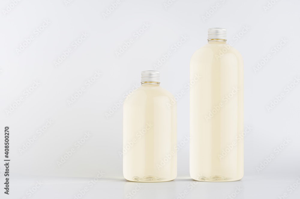 Set of two plastic tall and low bottles with pale fresh drink or cosmetic essential oil, silver cap mockup on white background, template, copy space. Set of two plastic tall and low bottles with pale fresh drink or cosmetic essential oil, silver cap mockup on white background, template, copy space.