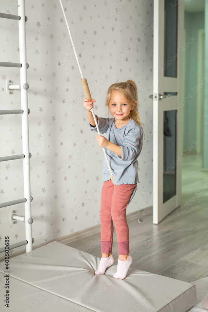 beautiful little girl doing home gymnastics beautiful little girl doing home gymnastics