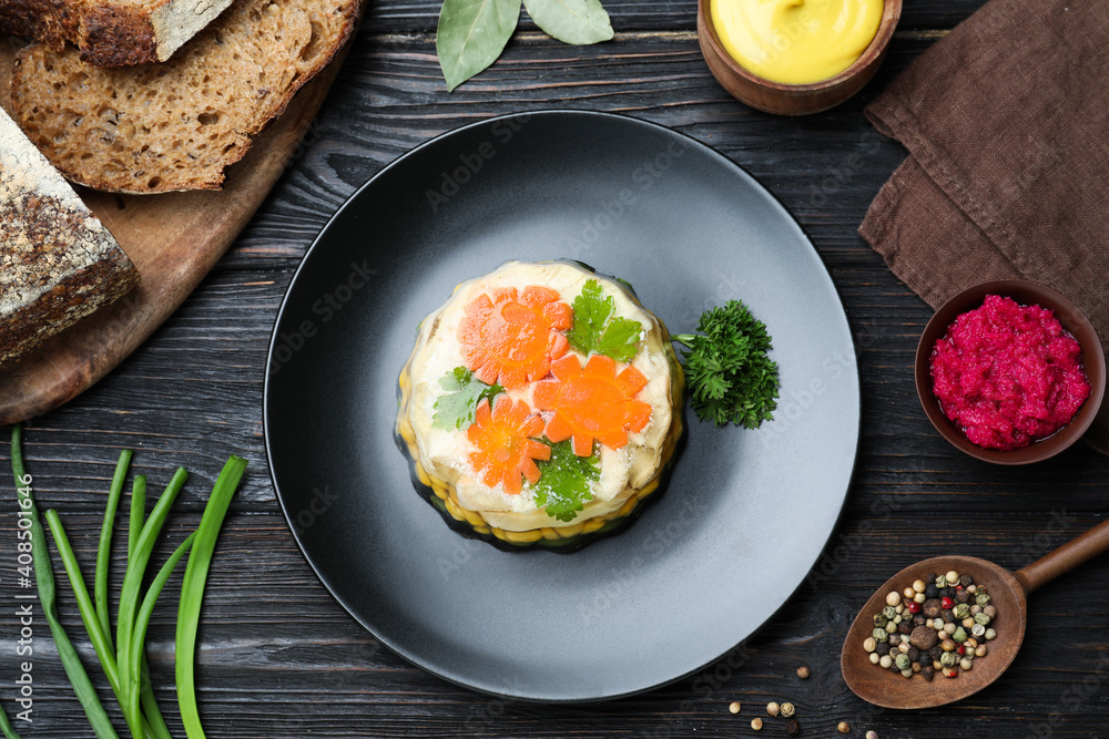 Delicious homemade chicken aspic served on black wooden table, flat lay Delicious homemade chicken aspic served on black wooden table, flat lay