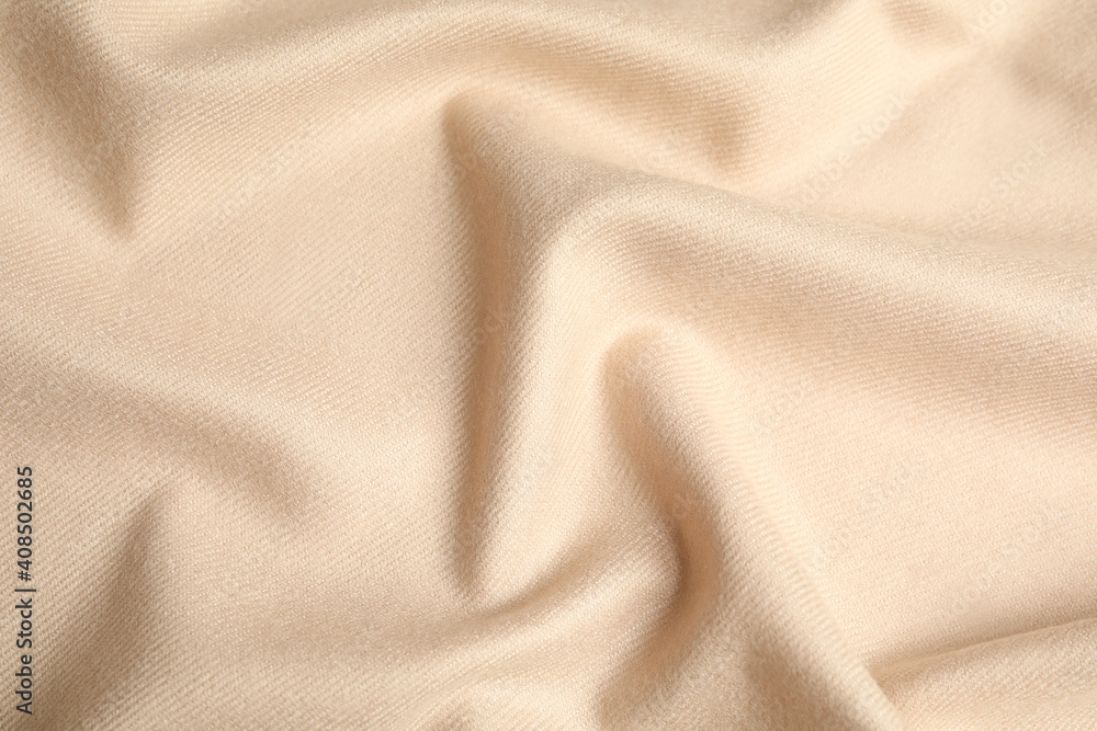 Fototapeta premium Beige soft cashmere fabric as background, closeup