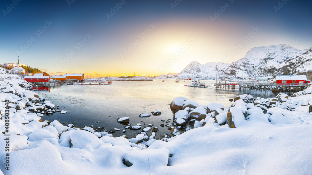 Stunning winter scenery of Moskenes village with ferryport and famous Moskenes parish Churc