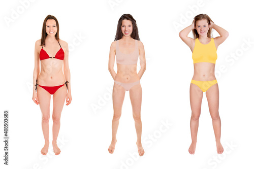 Full length portraits of three gorgeous laughing women wearing different bikinis, isolated in front of white studio background