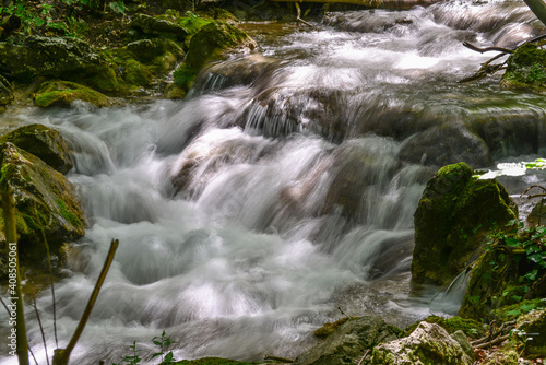 Rapids on the forest stream, Susara river, Romania. Waterfalls on the river current photo