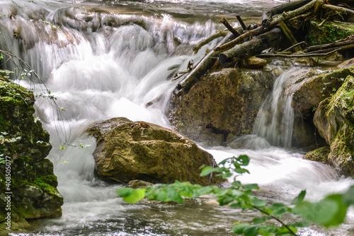 Rapids on the forest stream, Susara river, Romania. Waterfalls on the river current photo