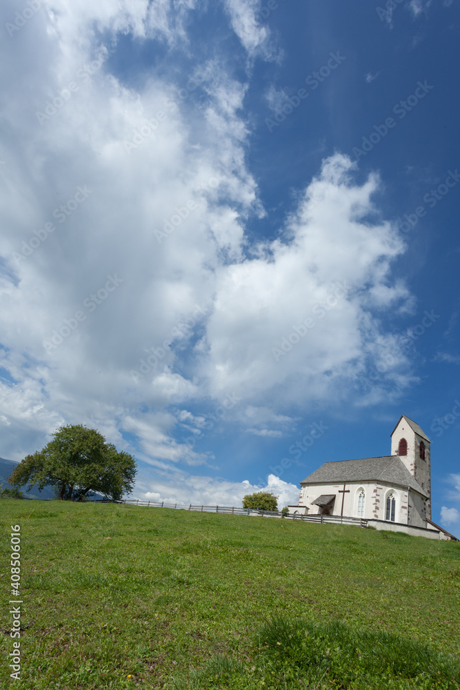 St. Giacomo little church among a wide green meadow in St. Giacomo town , Val di Funes St. Giacomo little church among a wide green meadow in St. Giacomo town , Val di Funes