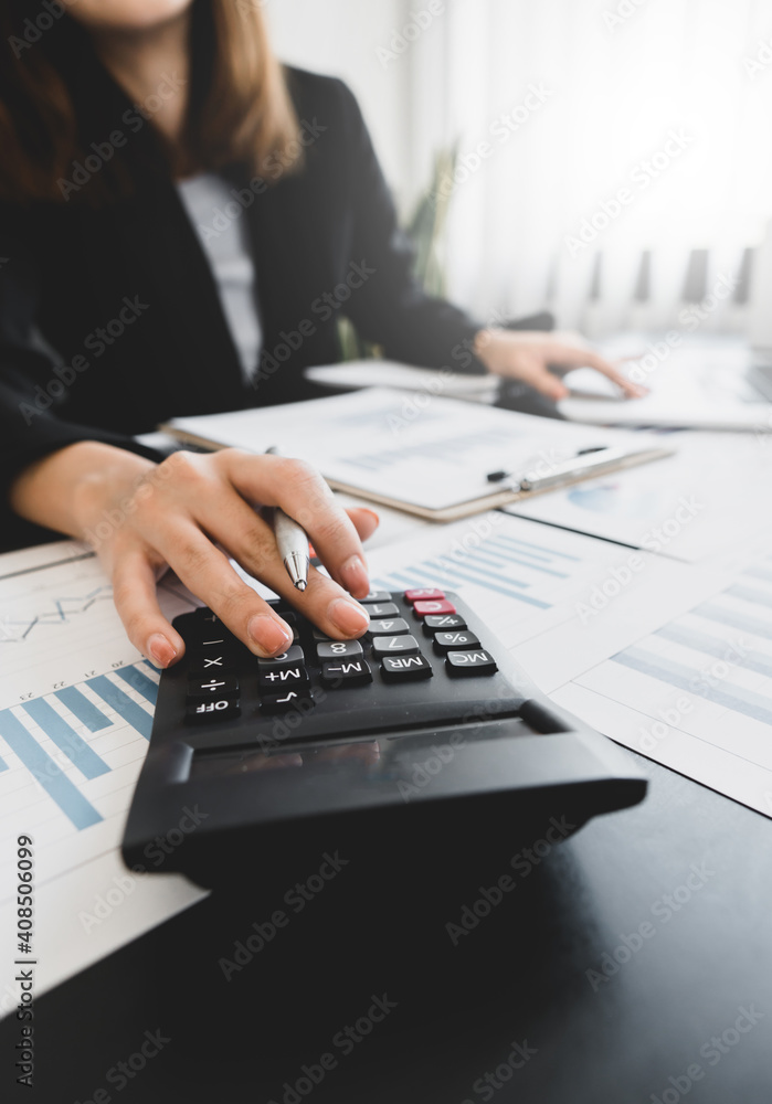 employee accountant man hand press on calculator for make financial report or company's profit monthly at desk , bookkeeper job and work from home concept employee accountant man hand press on calculator for make financial report or company's profit monthly at desk , bookkeeper job and work from home concept