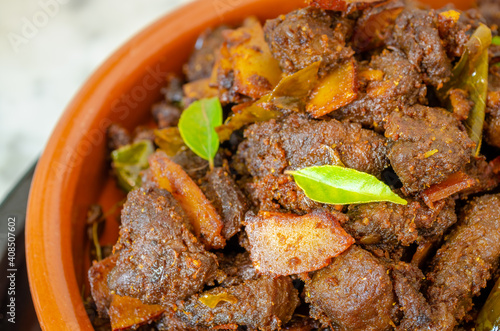 Closeup of a very tasty coconut beef fry in Kerala style preparation photo